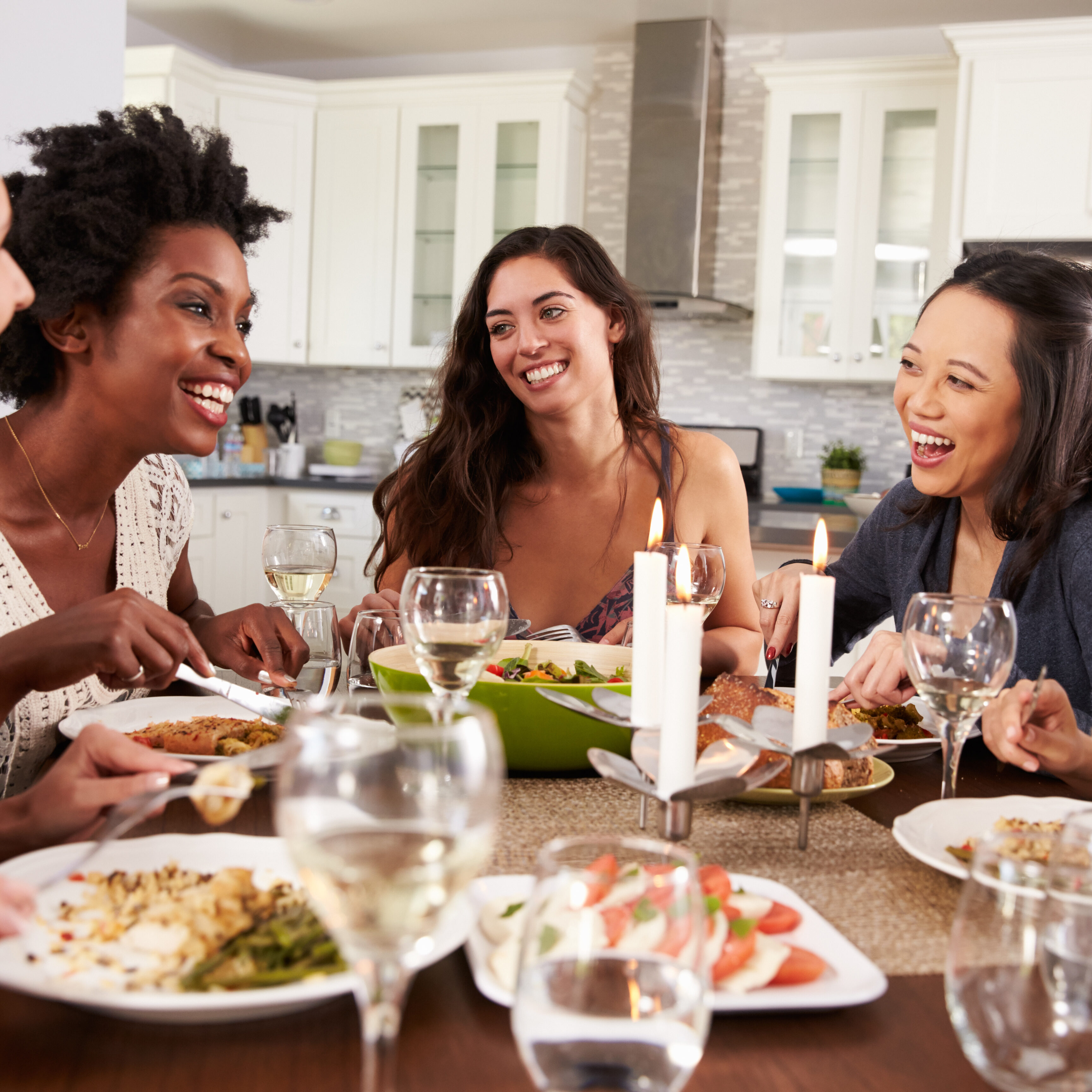 Group Of Female Friends Enjoying Dinner Party At Home